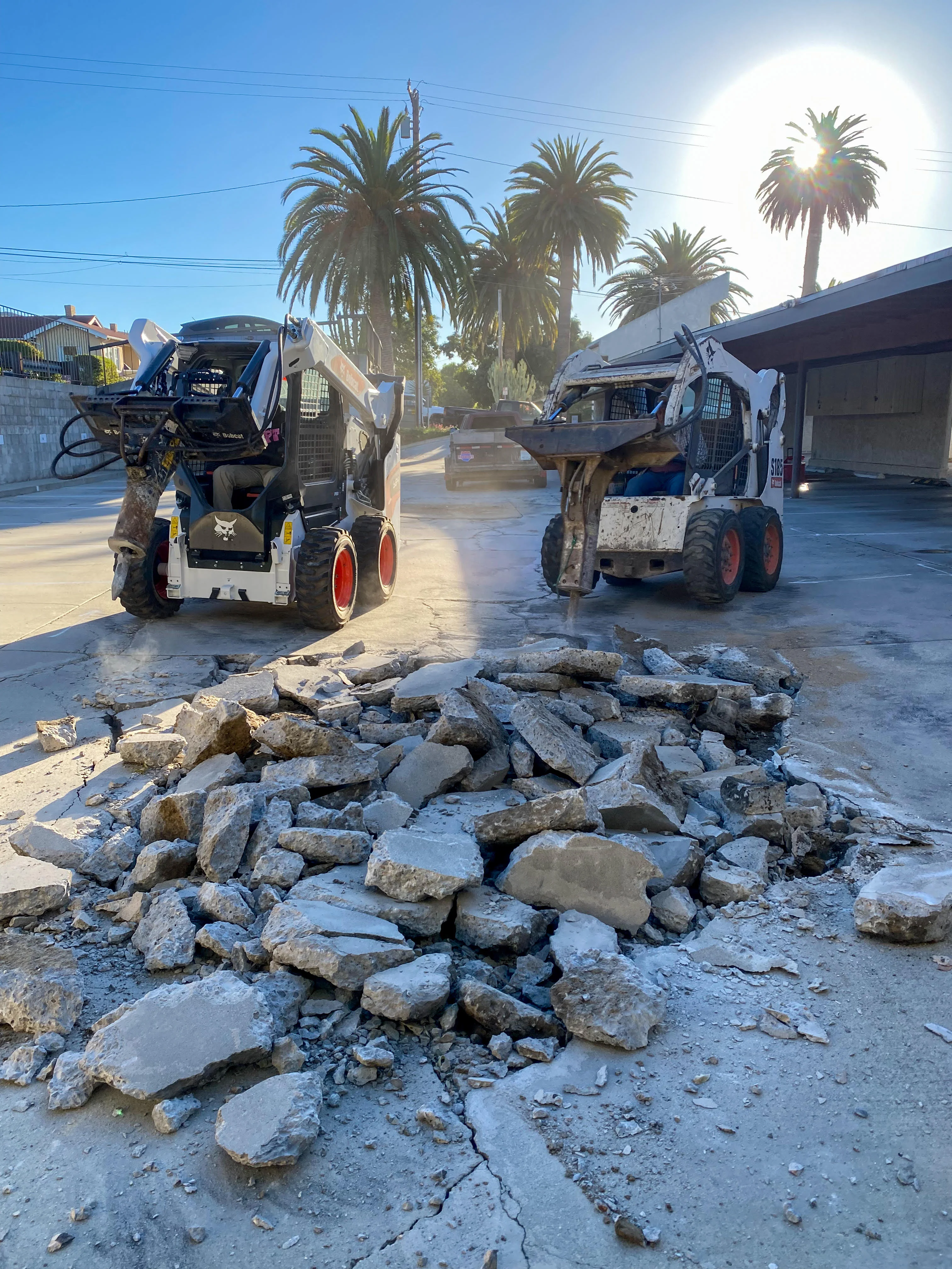Professional demolition crew removing concrete with heavy equipment in Oxnard